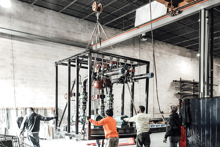 four Modular workers lifting equipment together