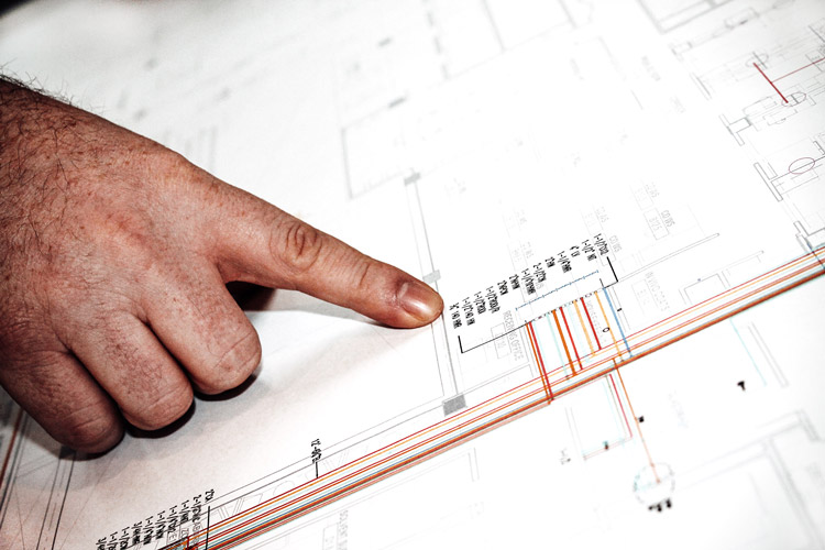 hand on paper, pointing at unit numbers